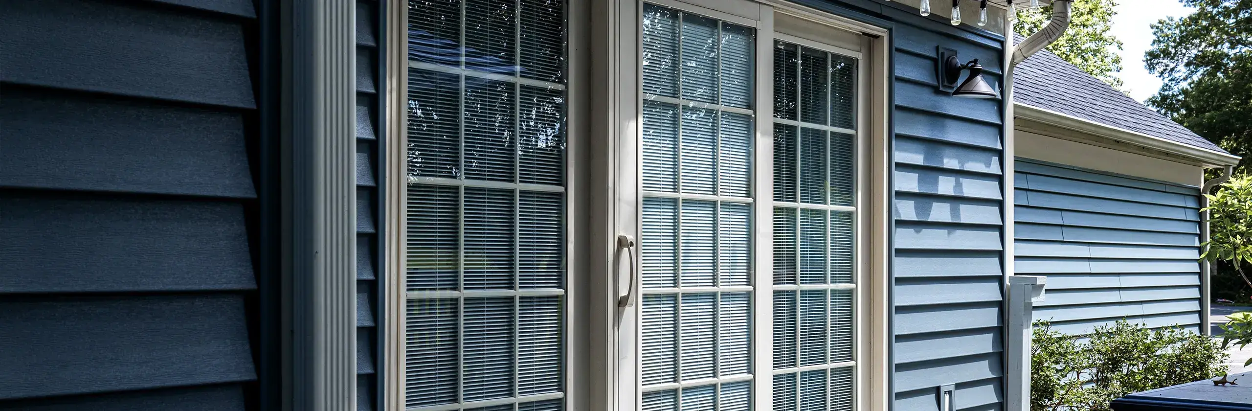 Siding with a new patio sliding glass door.