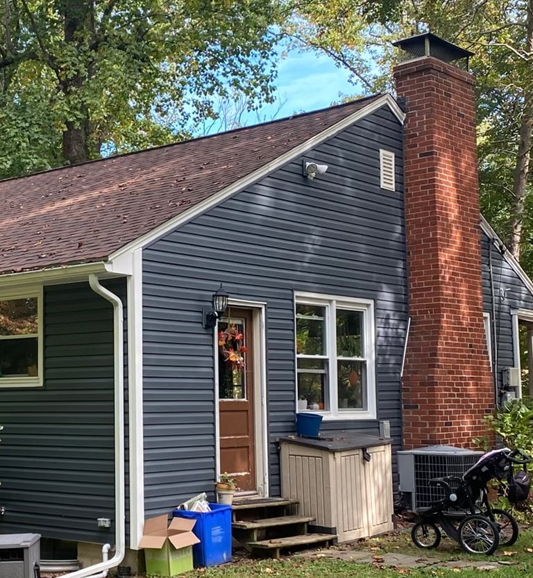 Dark Blue vinyl siding with white trim. 