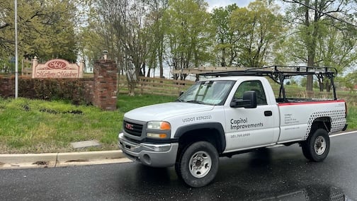 Photo of Marlboro Meadows neighborhood sign with the capitol improvements roofing truck.