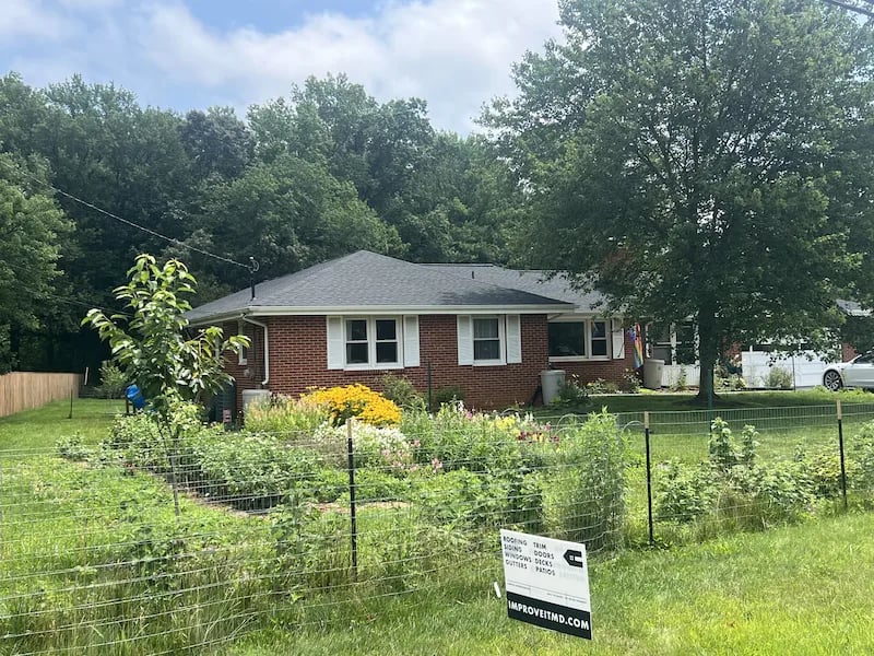 Photo of a Finished Roof In Silver Spring MD with Capitol Improvements Sign in the Front Lawn